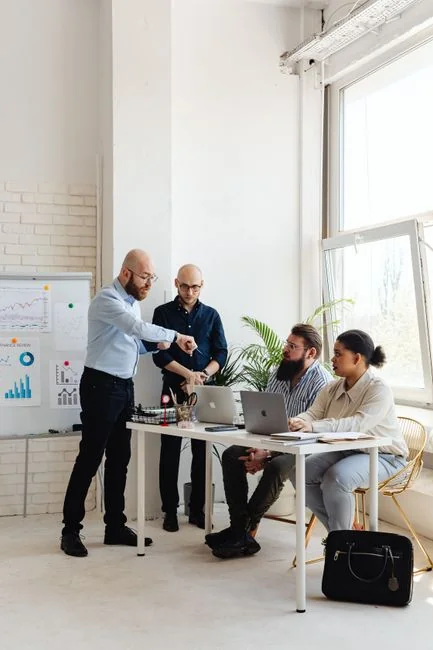 Two colleagues collaborate on a marketing strategy using a whiteboard, focusing on user-generated content.